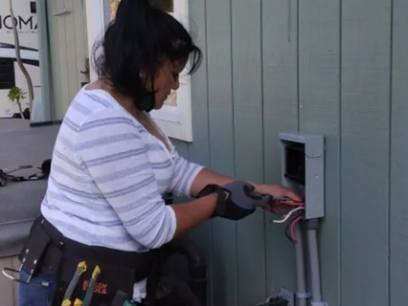 Licensed electrician wiring an exterior subpanel in Okmulgee